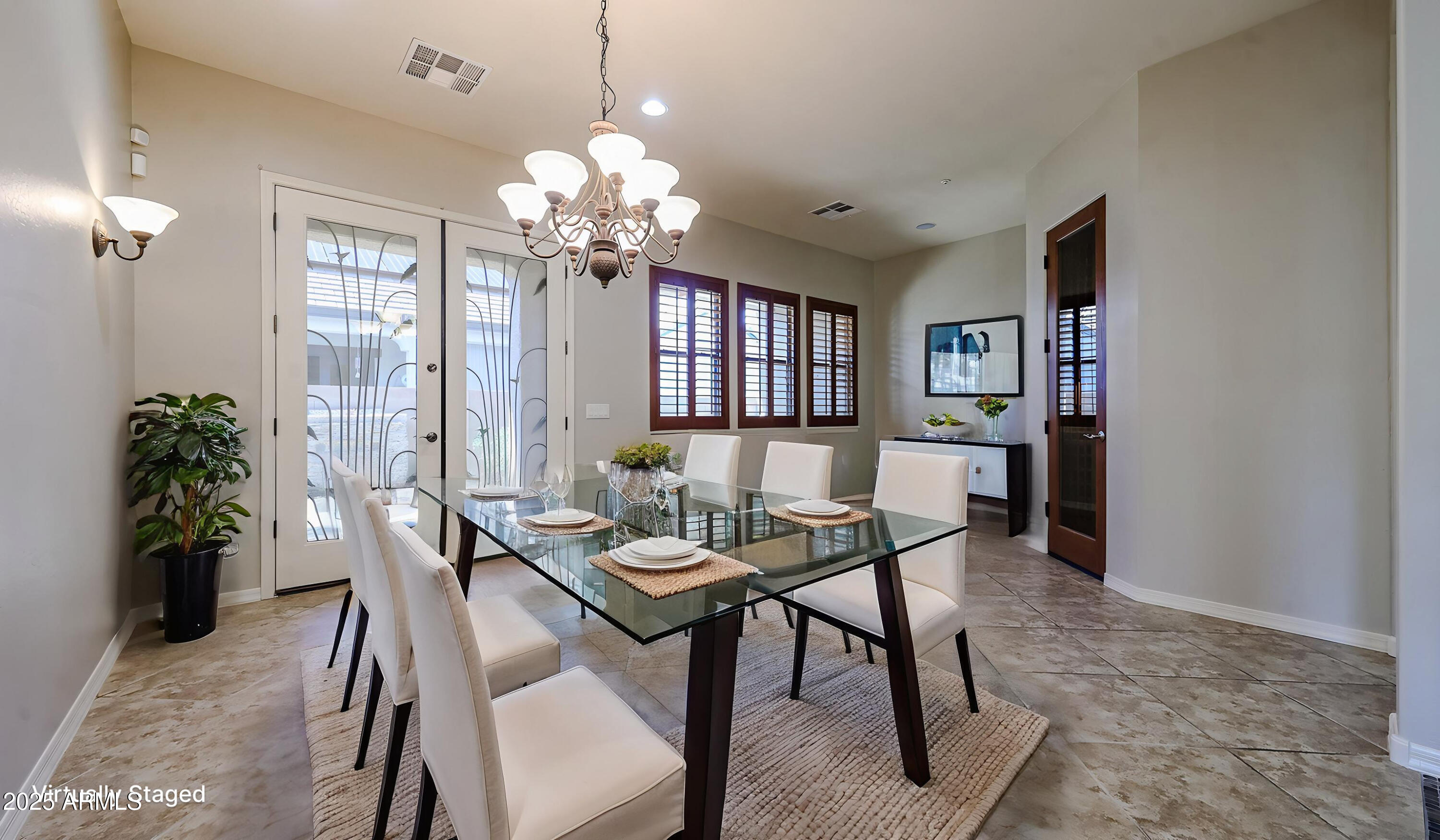 18391 Verdin Road Goodyear, AZ 85338 - Photo 11 of 94 a view of a dining room with furniture and chandelier