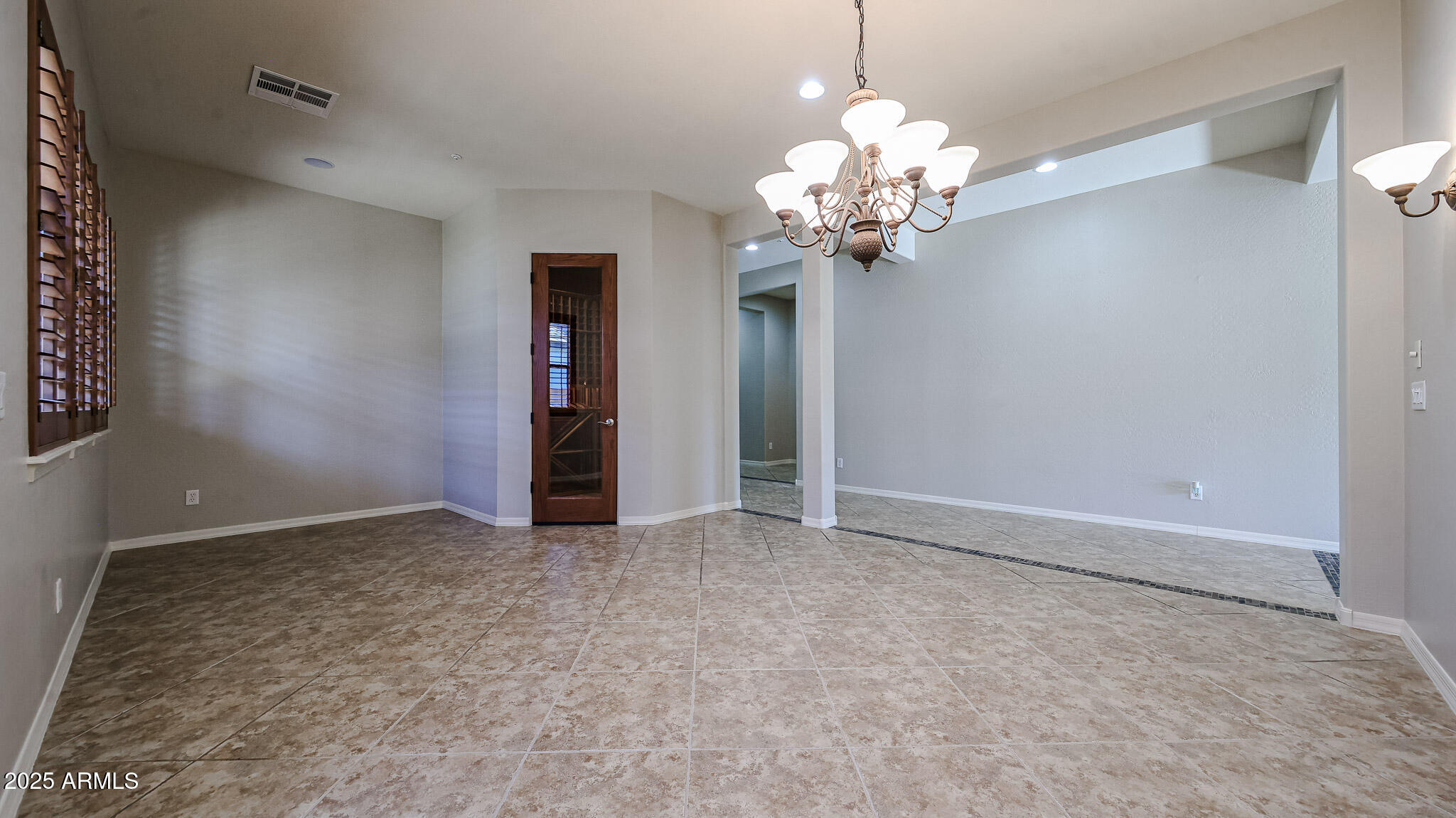 18391 Verdin Road Goodyear, AZ 85338 - Photo 13 of 94 a view of an empty room with a chandelier fan