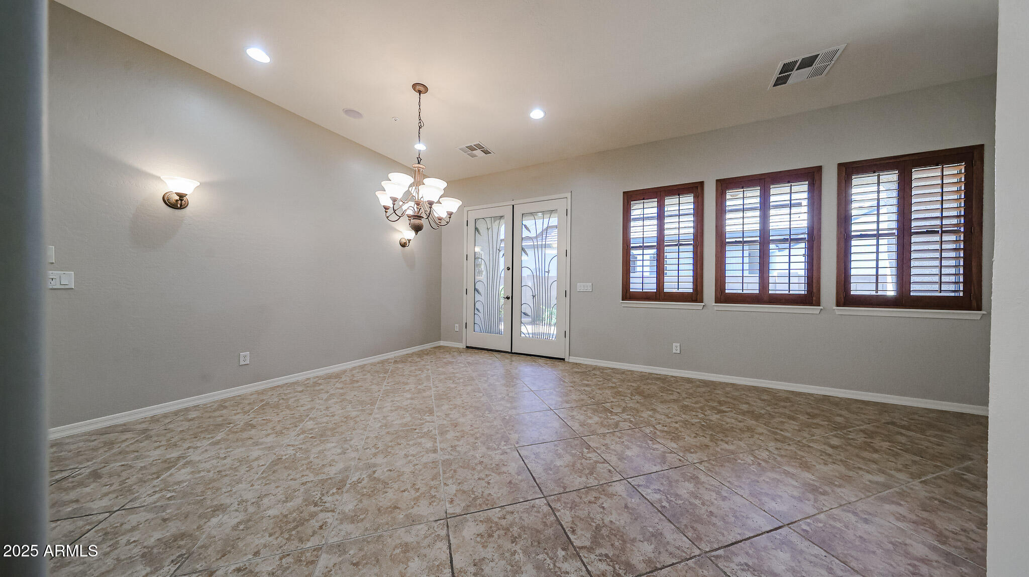 18391 Verdin Road Goodyear, AZ 85338 - Photo 17 of 94 a view of an empty room with a window