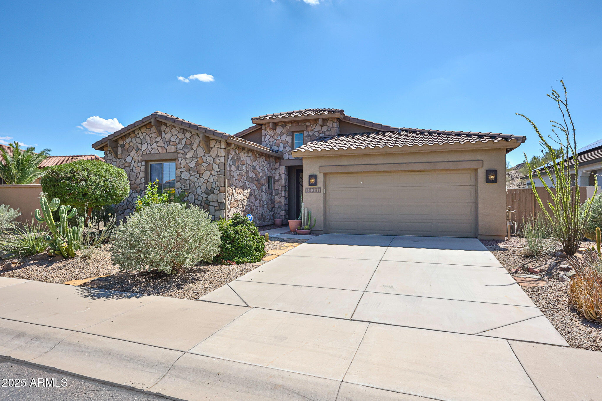 18391 Verdin Road Goodyear, AZ 85338 - Photo 2 of 94 a front view of a house with plants