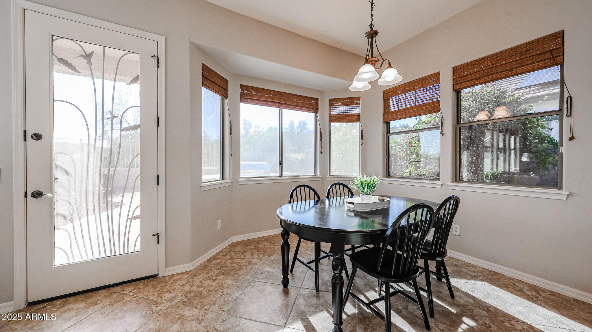 18391 Verdin Road Goodyear, AZ 85338 - Photo 24 of 94 a dining room with furniture window and wooden floor