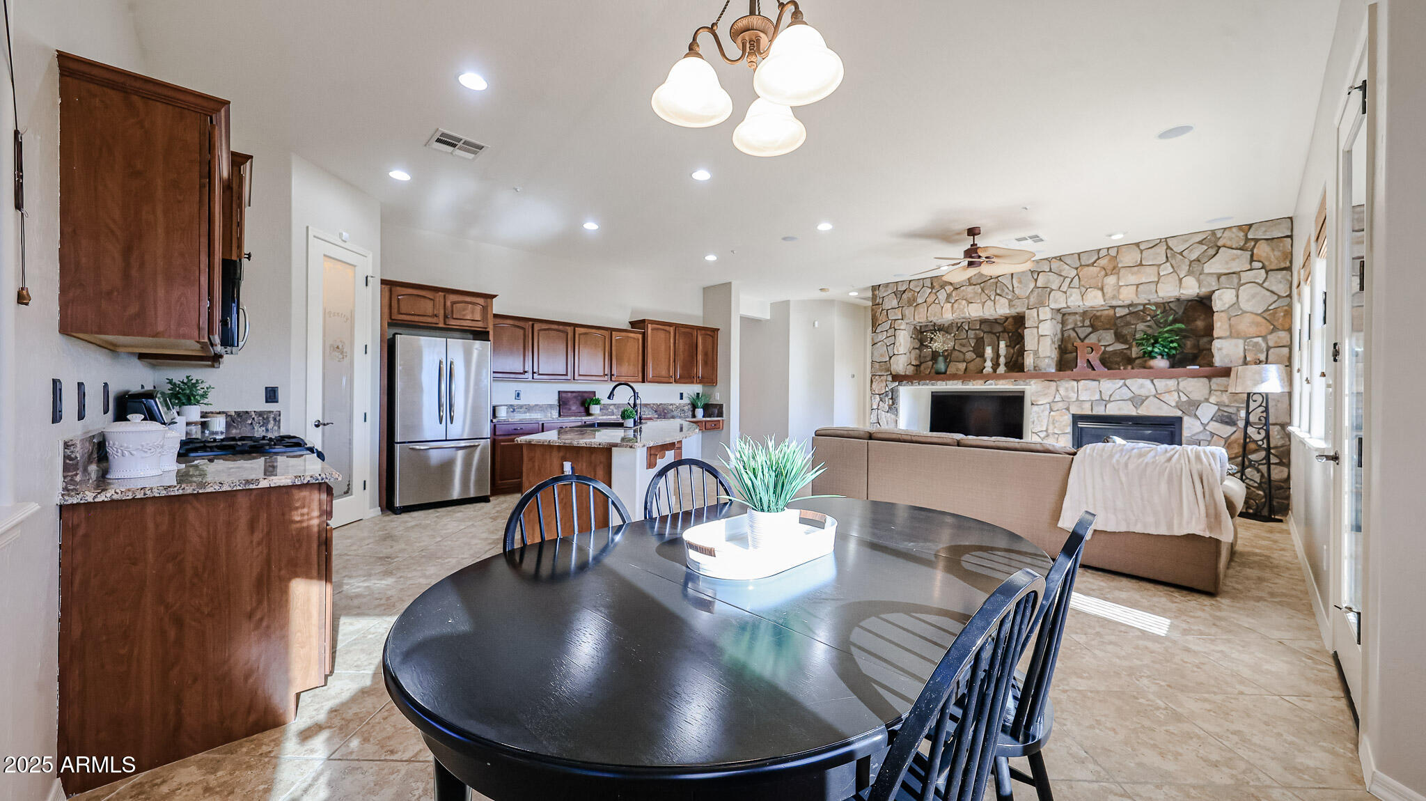 18391 Verdin Road Goodyear, AZ 85338 - Photo 25 of 94 a dining room with furniture and a chandelier