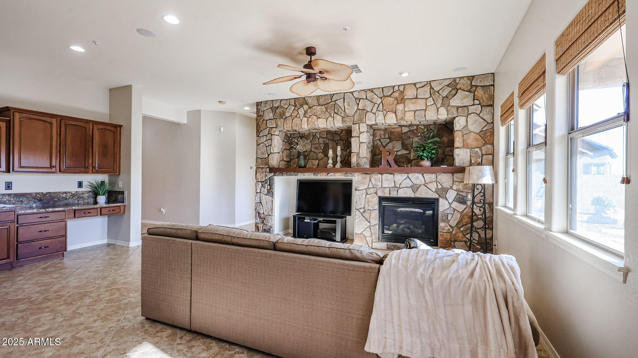 18391 Verdin Road Goodyear, AZ 85338 - Photo 26 of 94 a living room with furniture and a fireplace