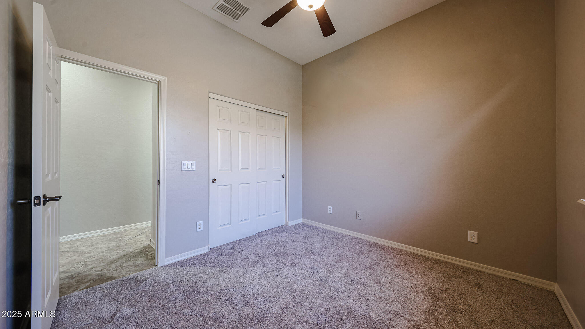 18391 Verdin Road Goodyear, AZ 85338 - Photo 43 of 94 an empty room with a ceiling fan and a window