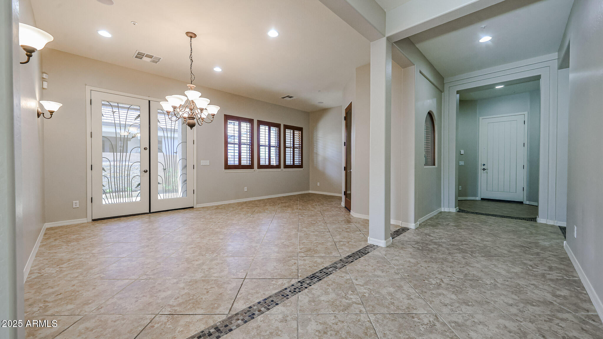 18391 Verdin Road Goodyear, AZ 85338 - Photo 10 of 94 an empty room with stairs and wooden floor