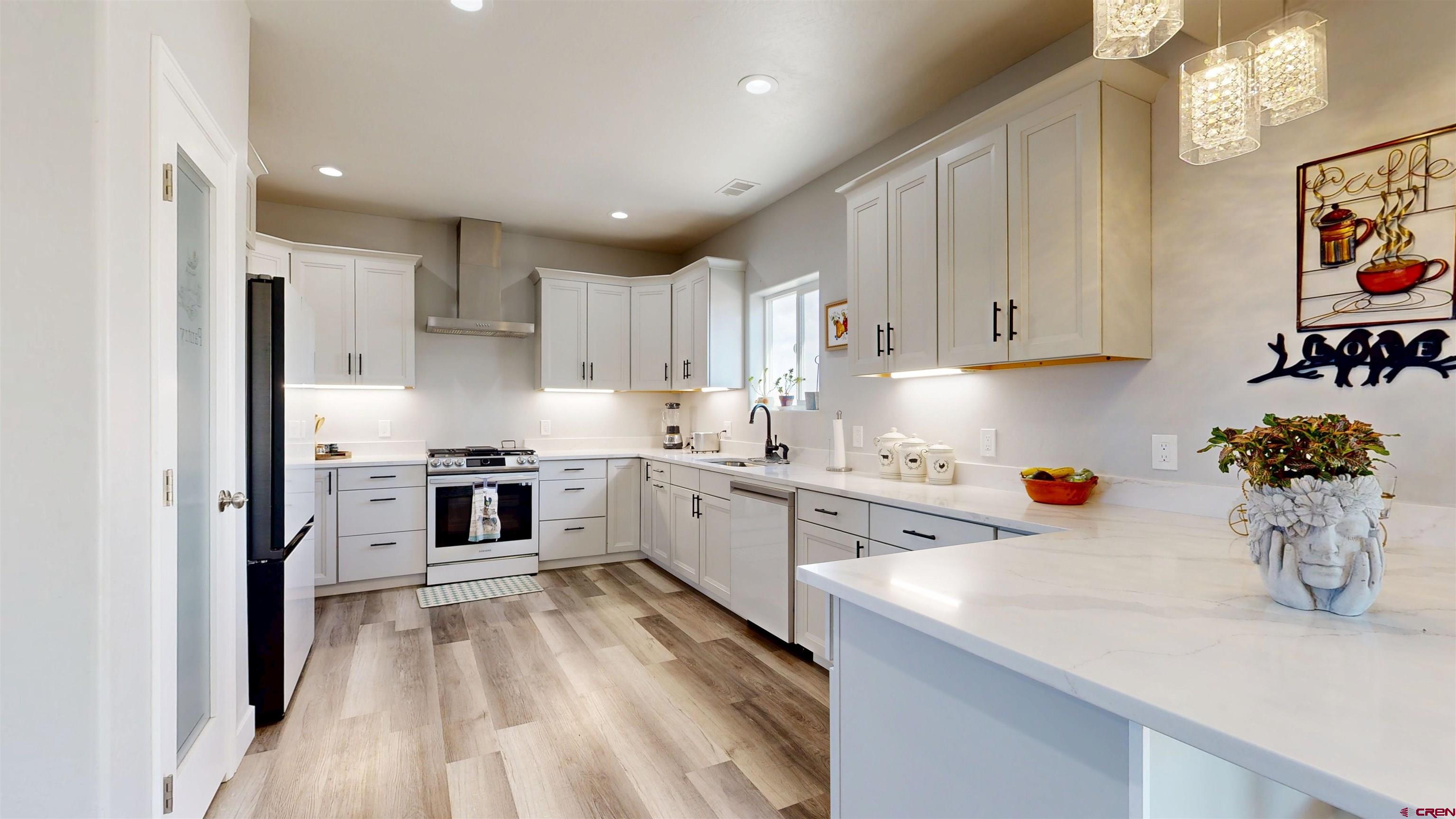 a kitchen with white cabinets and white appliances