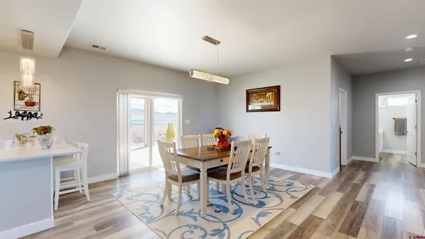 a living room with furniture a wooden floor and a large window