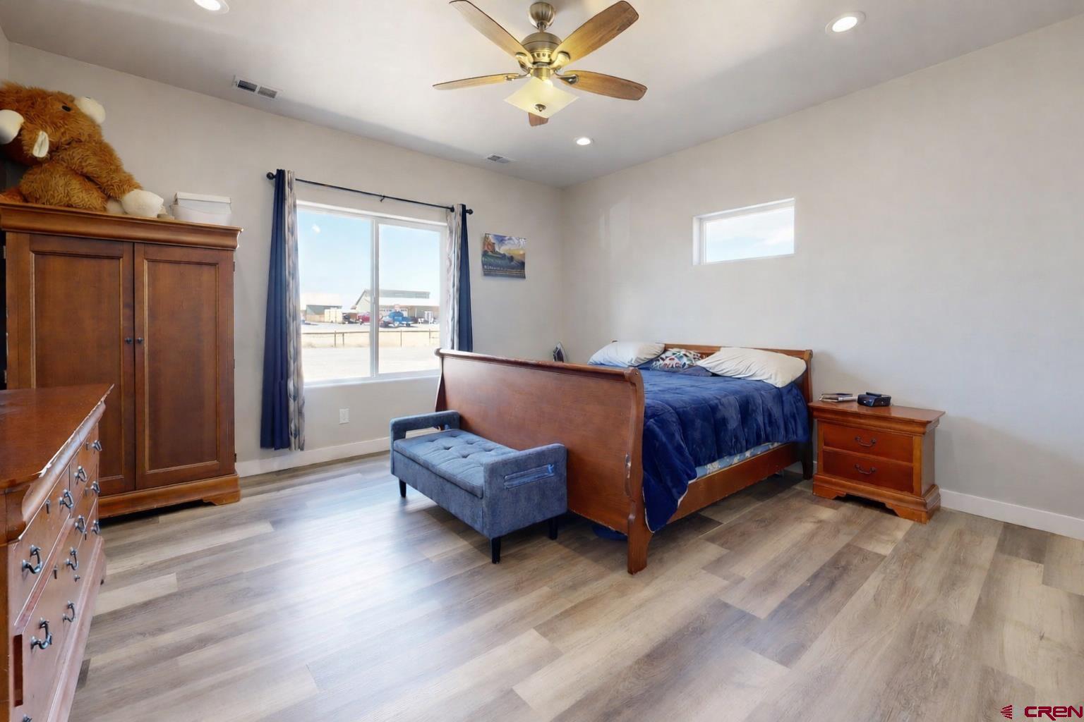 3728 Ruth Lane Delta, CO 81416 - Photo 13 of 34 a bedroom with a bed and a chandelier