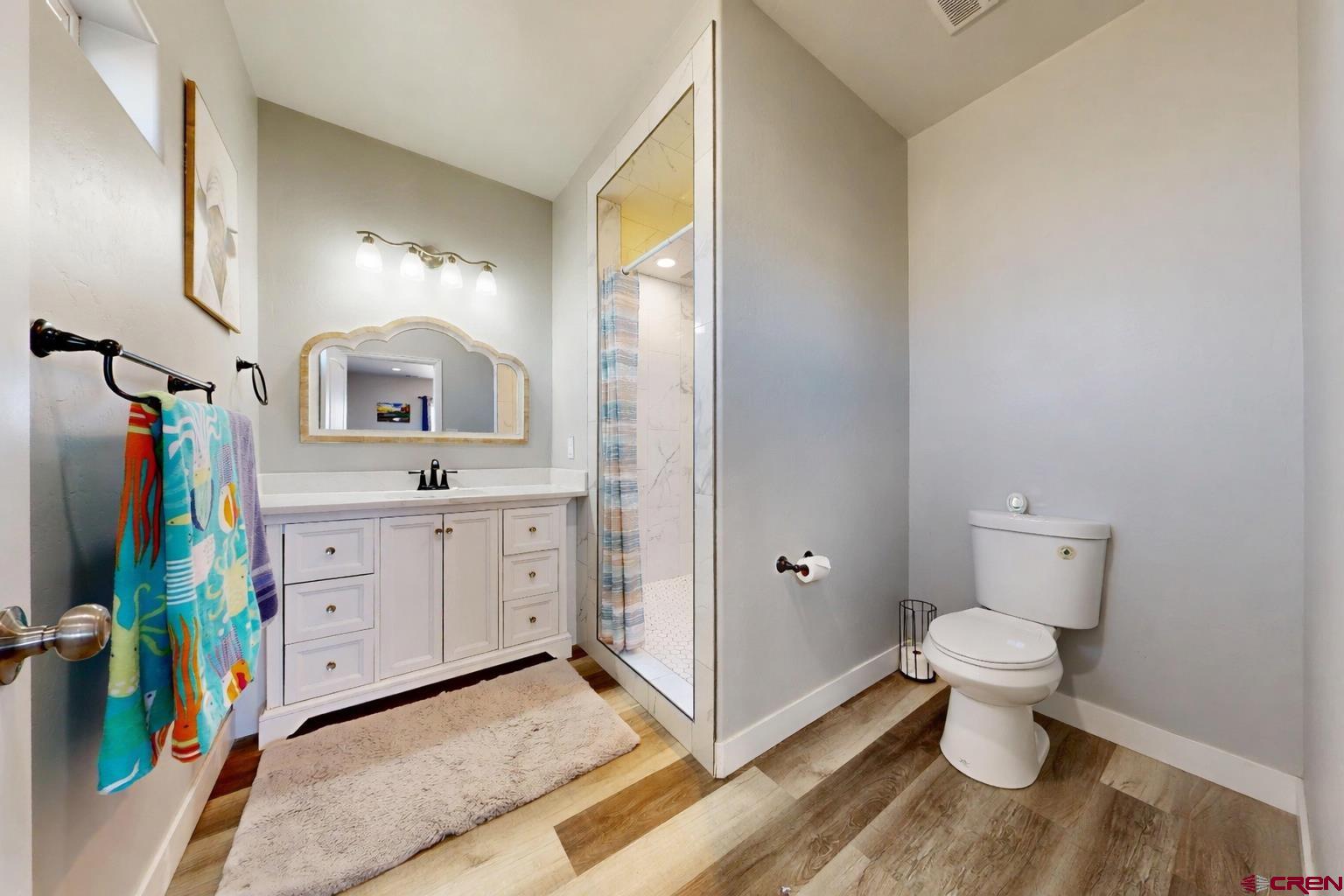 3728 Ruth Lane Delta, CO 81416 - Photo 15 of 34 a spacious bathroom with a toilet sink and a mirror