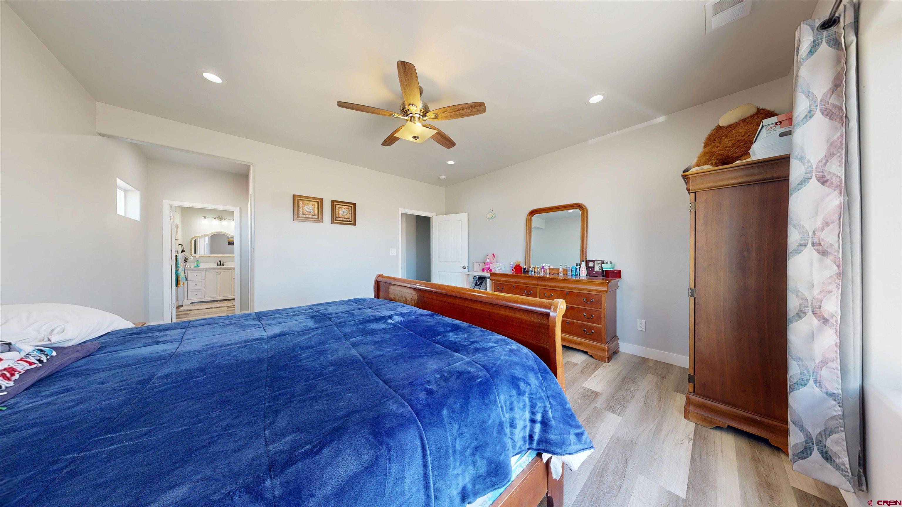 3728 Ruth Lane Delta, CO 81416 - Photo 16 of 34 a bed room with a bed and a chandelier