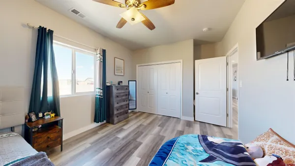 a bedroom with furniture and a flat screen tv