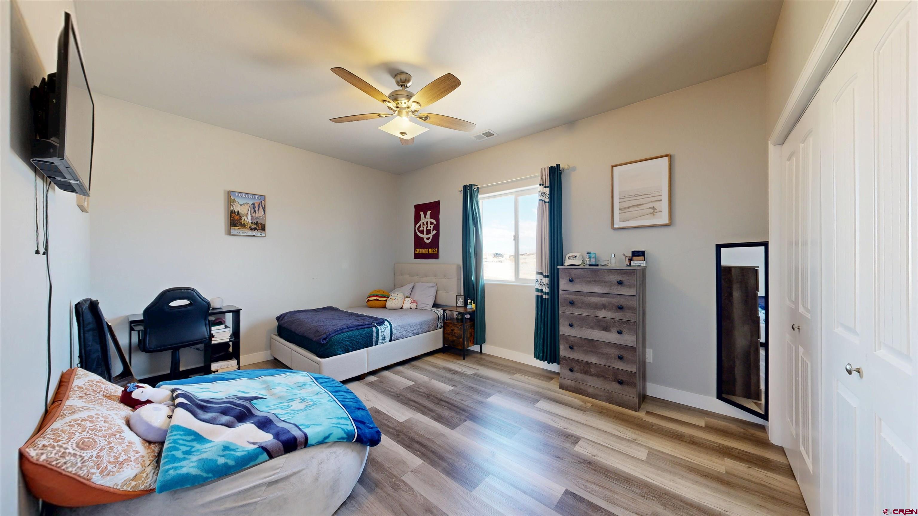 3728 Ruth Lane Delta, CO 81416 - Photo 22 of 34 a bedroom with furniture and a flat screen tv