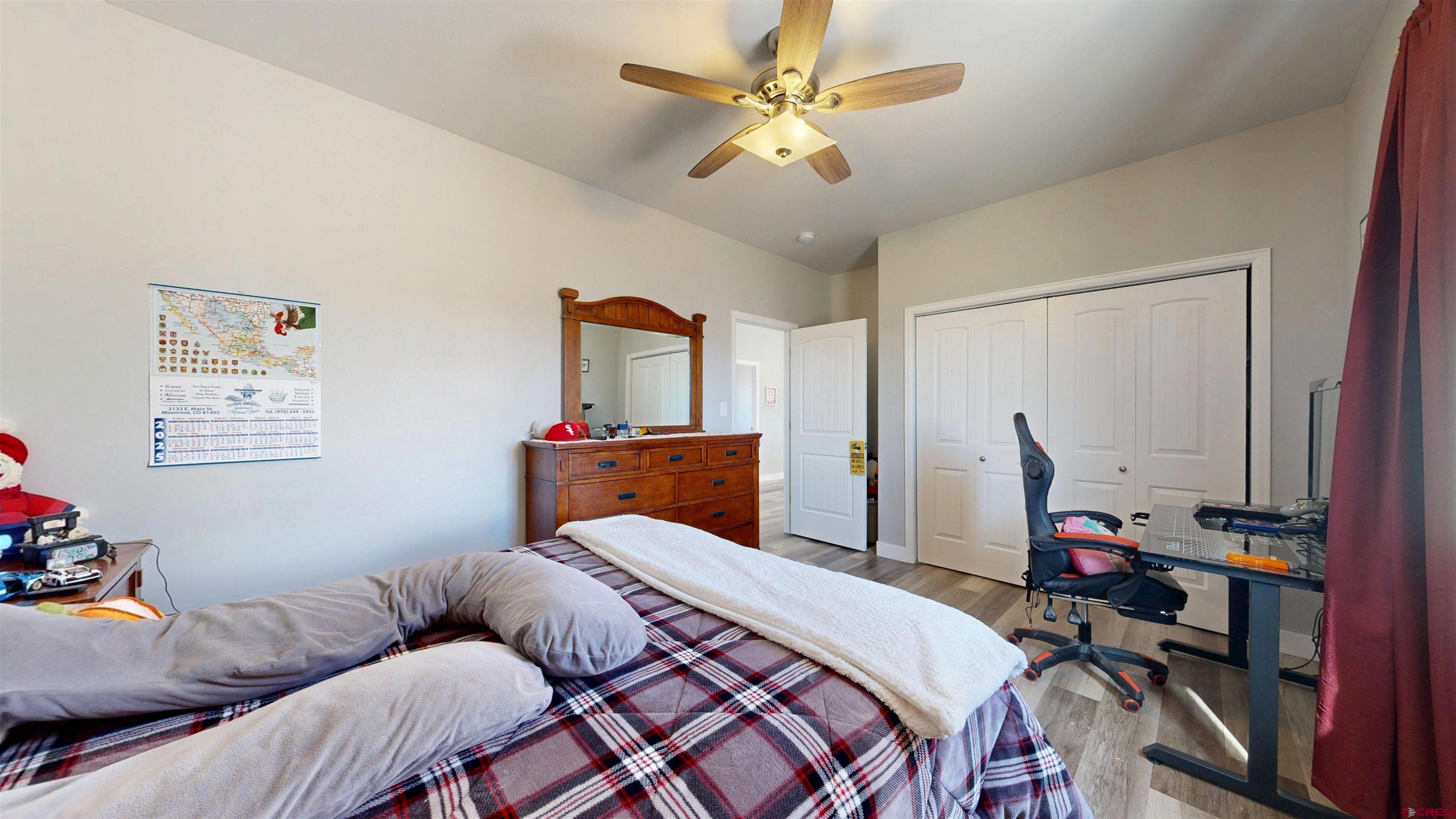 3728 Ruth Lane Delta, CO 81416 - Photo 23 of 34 a bedroom with a bed and a chandelier