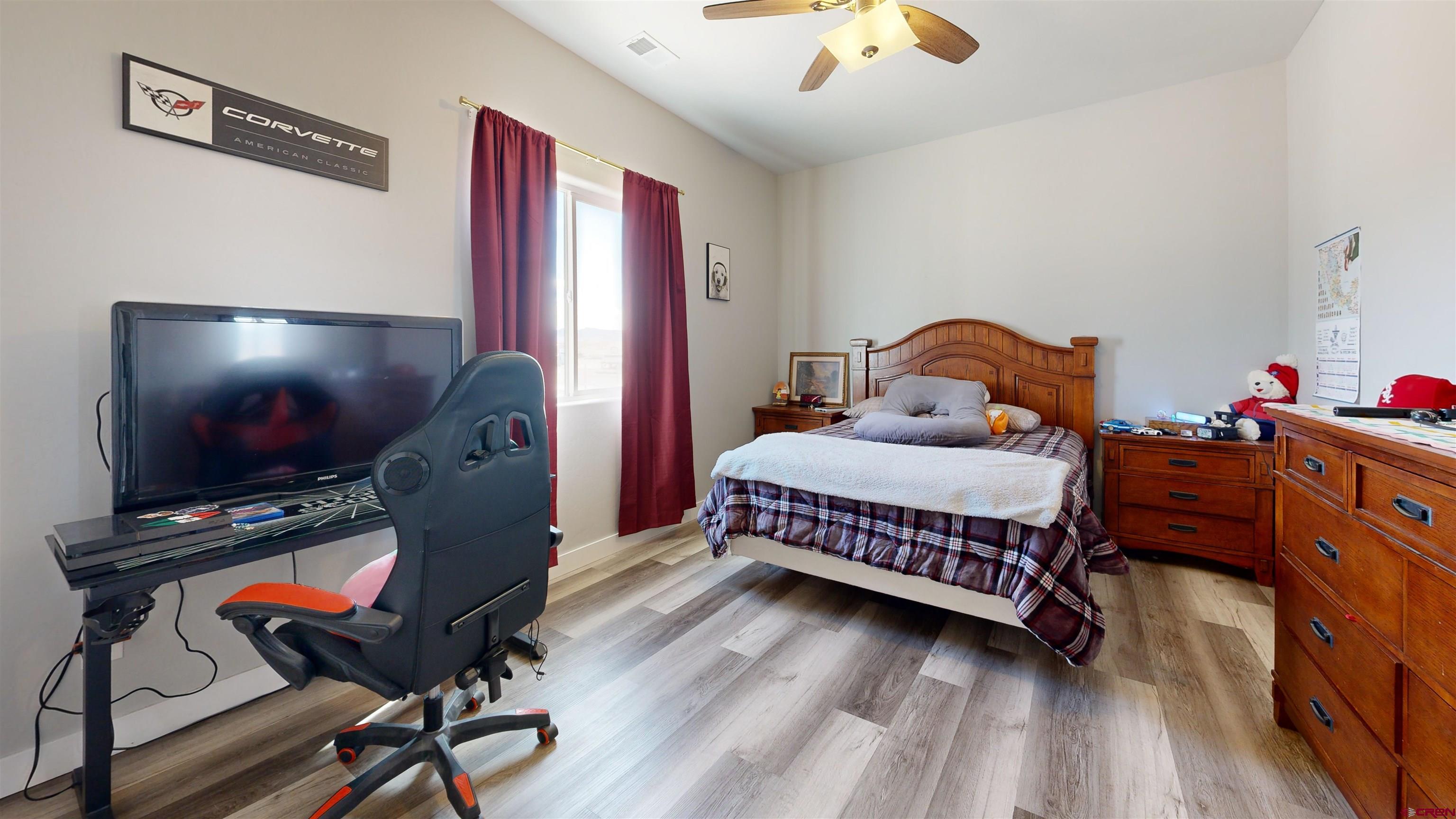 3728 Ruth Lane Delta, CO 81416 - Photo 24 of 34 a bedroom with a bed and wooden floor