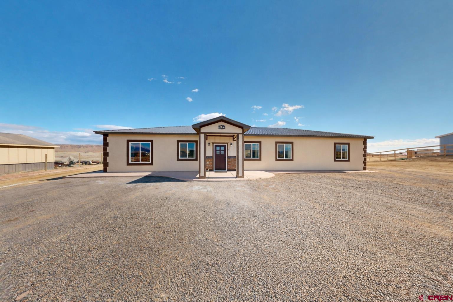 3728 Ruth Lane Delta, CO 81416 - Photo 31 of 34 a front view of a house with a street