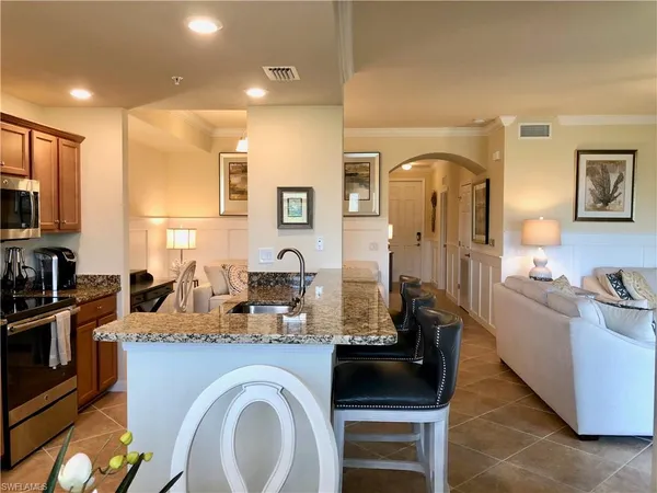 a kitchen with sink refrigerator and stove