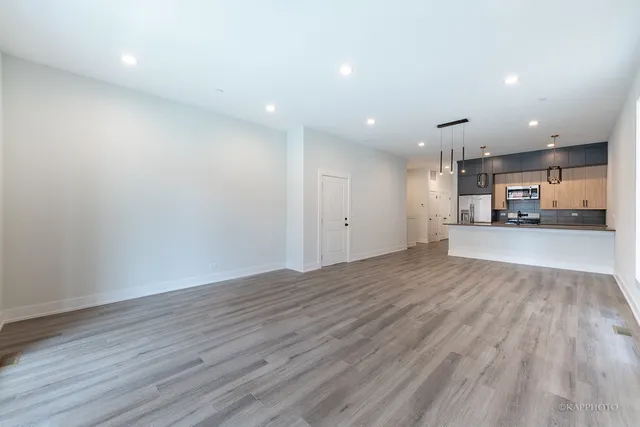 a kitchen with stainless steel appliances a sink a stove and cabinets