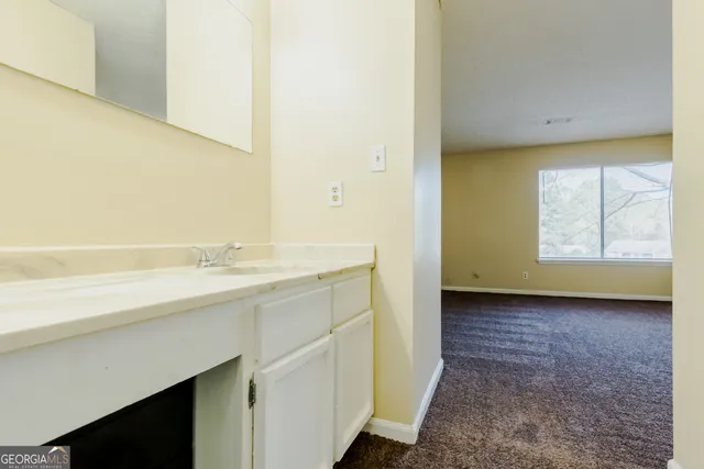 a view of a bathroom with a sink and a window