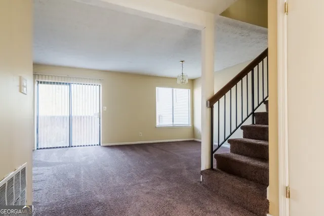 a view of an empty room with stairs
