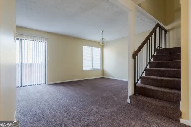 a view of an empty room with stairs