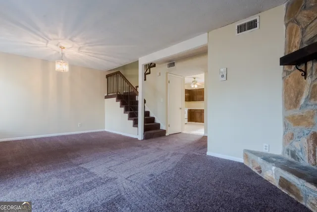an empty room with windows and closet