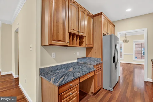 a kitchen with stainless steel appliances granite countertop a refrigerator and a stove top oven