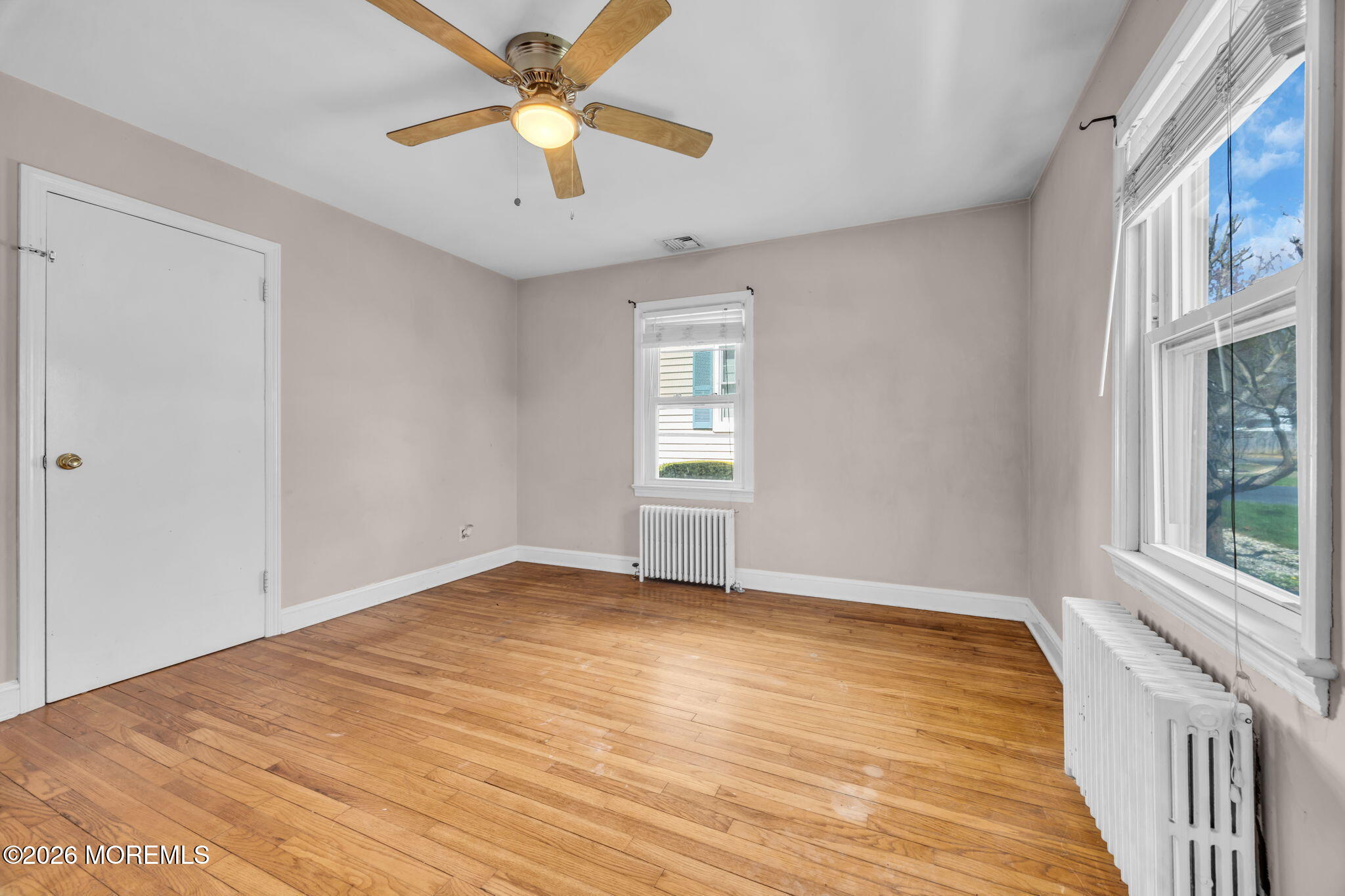 23 Spring Street Freehold, NJ 07728 - Photo 12 of 31 wooden floor in an empty room with a window