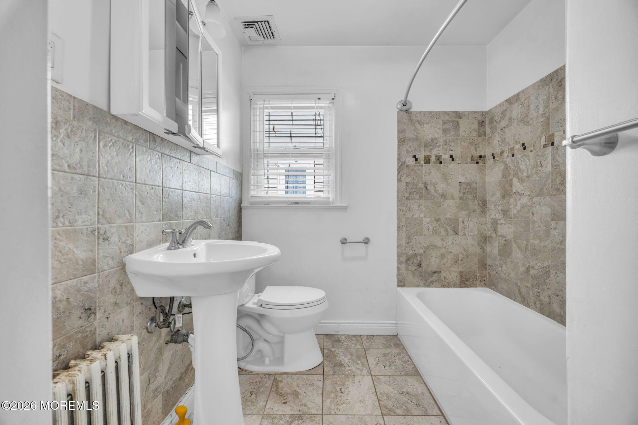 23 Spring Street Freehold, NJ 07728 - Photo 13 of 31 a bathroom with a sink a toilet and bathtub