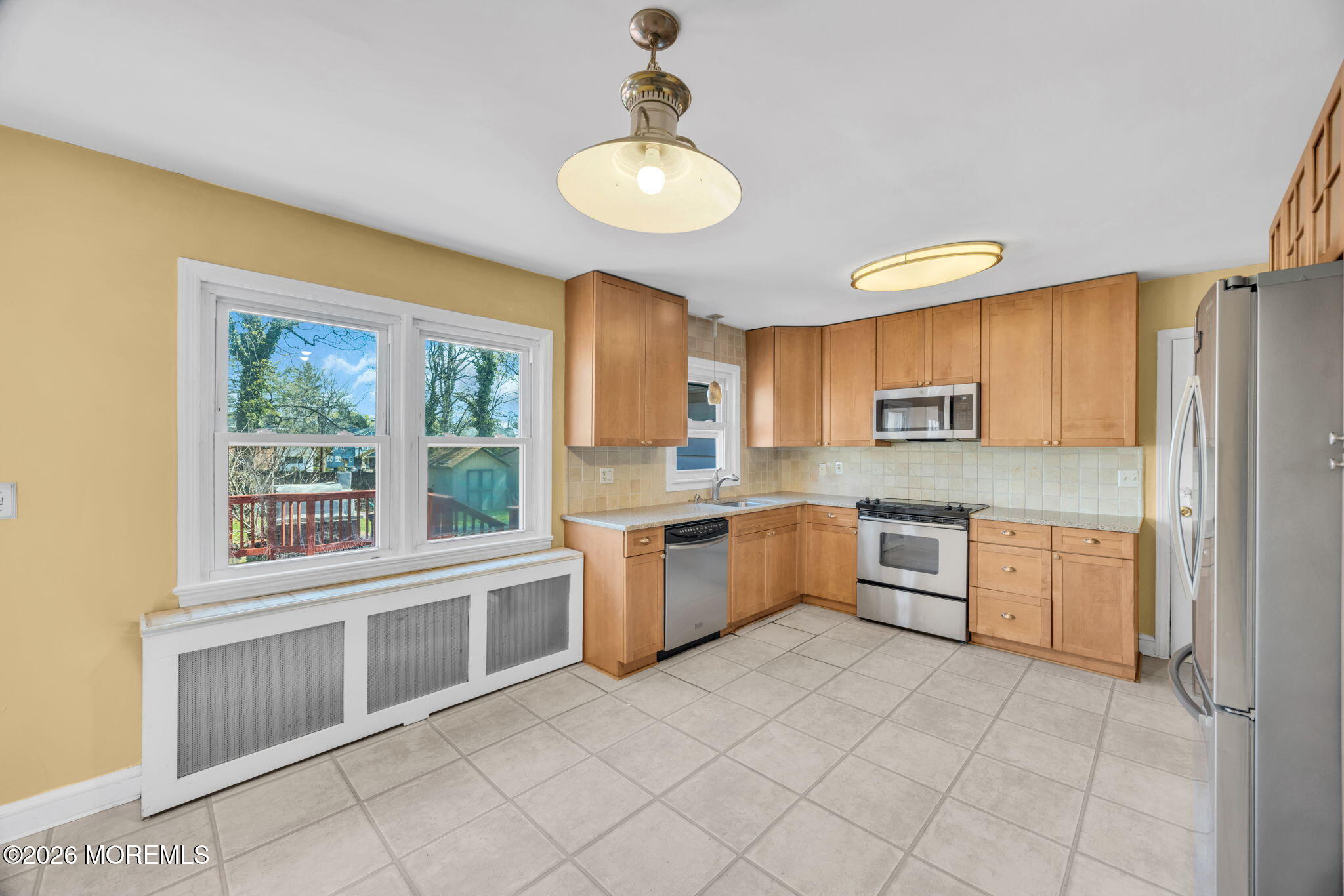 23 Spring Street Freehold, NJ 07728 - Photo 6 of 31 a kitchen with a stove a sink and a refrigerator