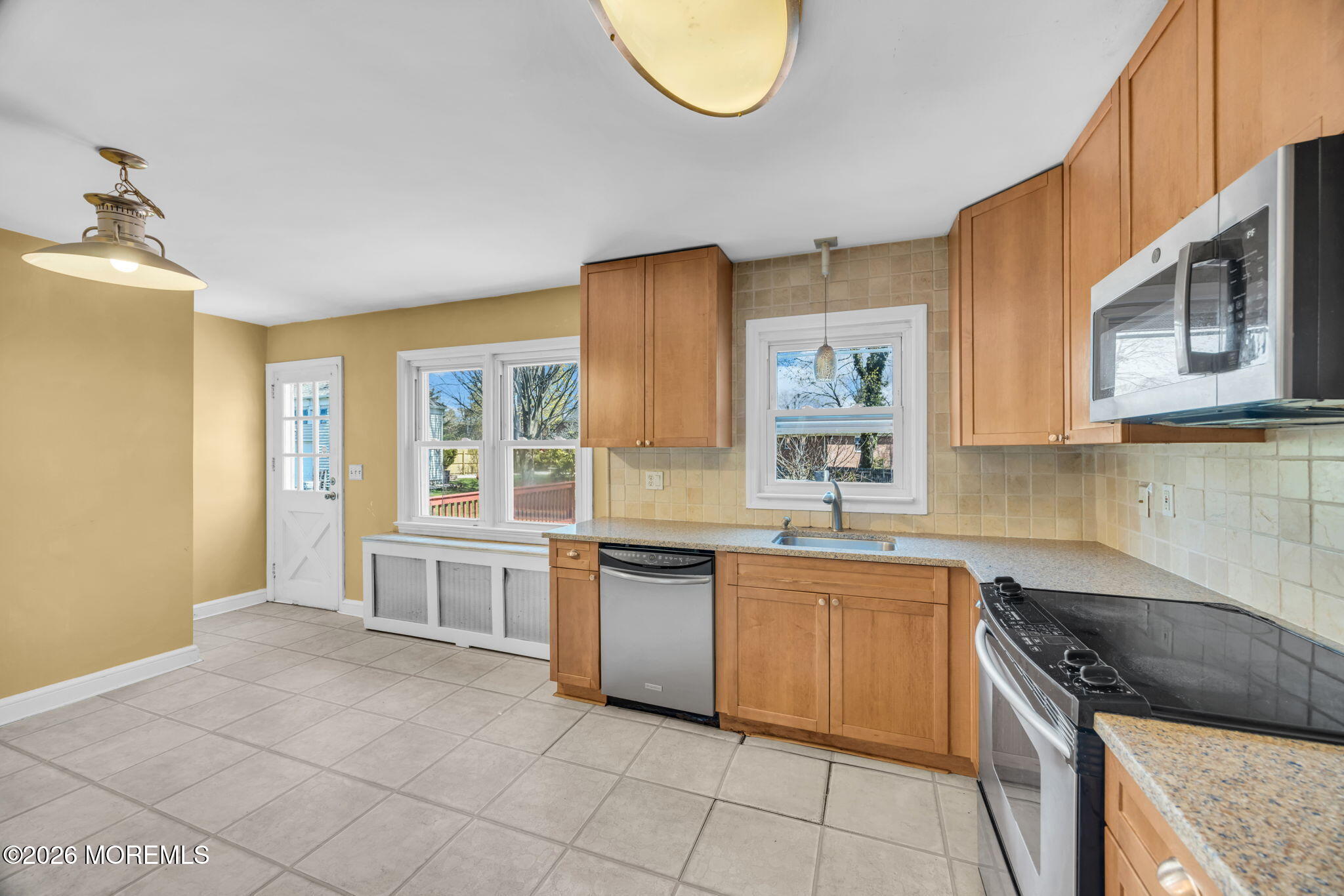 23 Spring Street Freehold, NJ 07728 - Photo 7 of 31 a kitchen with stainless steel appliances granite countertop a stove a sink and a microwave