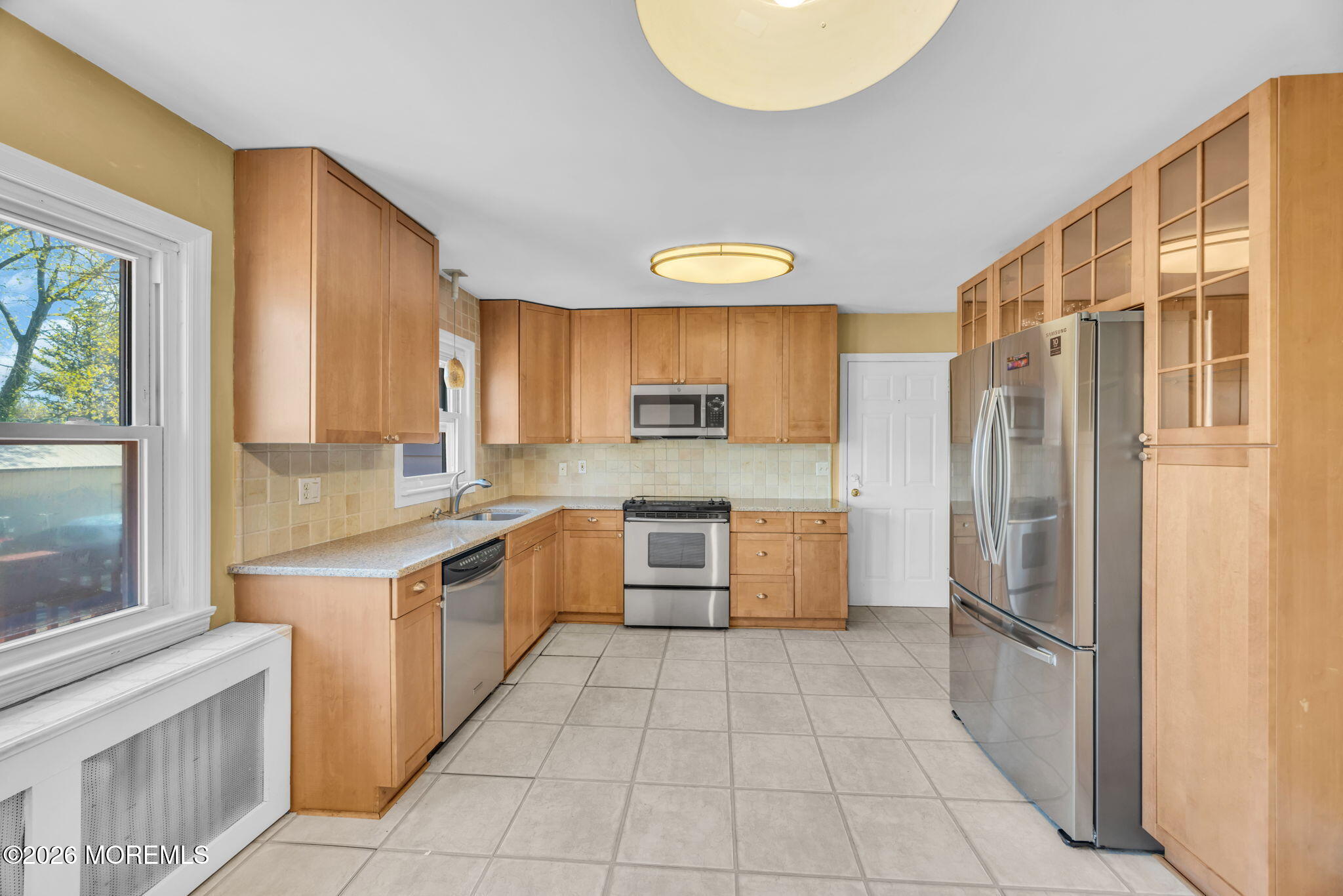 23 Spring Street Freehold, NJ 07728 - Photo 8 of 31 a large kitchen with a stove a refrigerator and a sink