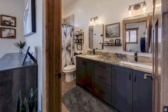 4173 Shadowfax Run, Unit 5 Moab, UT 84532 - Photo 28 of 41 Bathroom with double vanity, polished granite countertop and tiled bath/shower