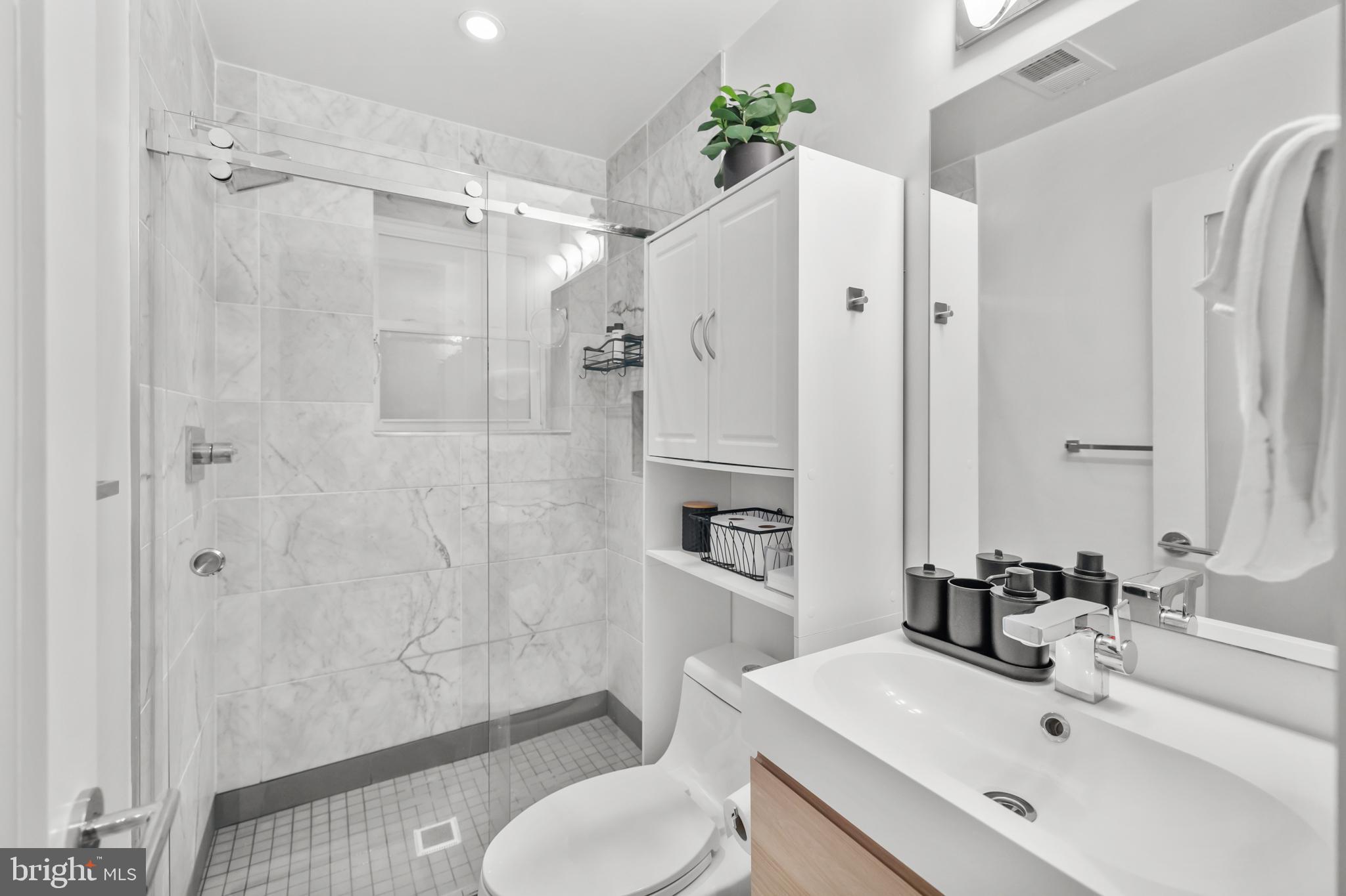 1324 W Street Northwest, Unit 1 Washington, DC 20009 - Photo 29 of 37 a bathroom with a sink toilet and shower