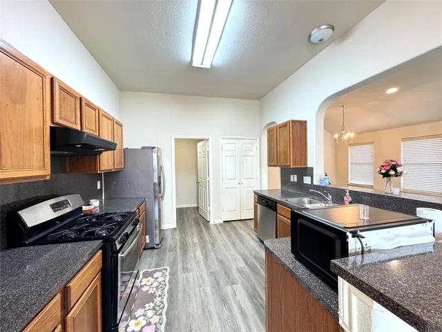 a kitchen with stainless steel appliances granite countertop a stove and a sink