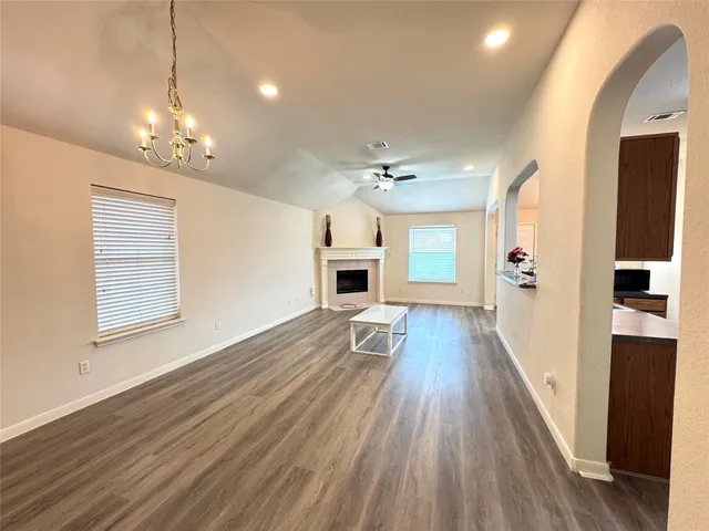 a view of a house with wooden floor and a ceiling fan