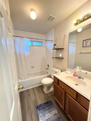 a bathroom with a double vanity sink toilet and shower