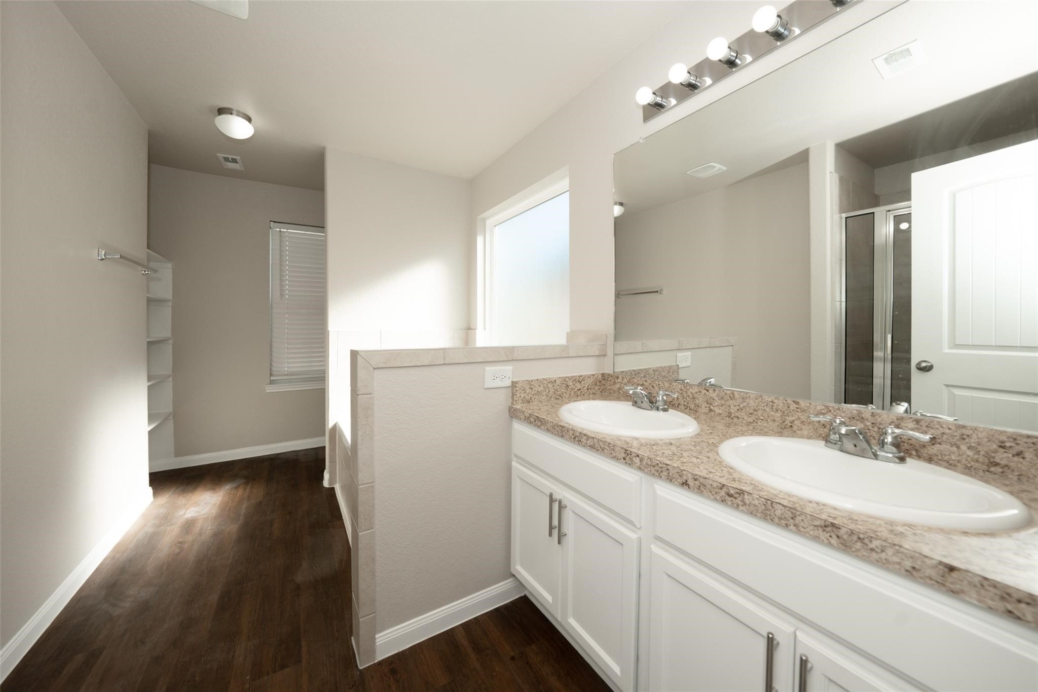 18834 Lansdowne Stream Path Katy, TX 77449 - Photo 14 of 21 a bathroom with a granite countertop sink a mirror and a shower