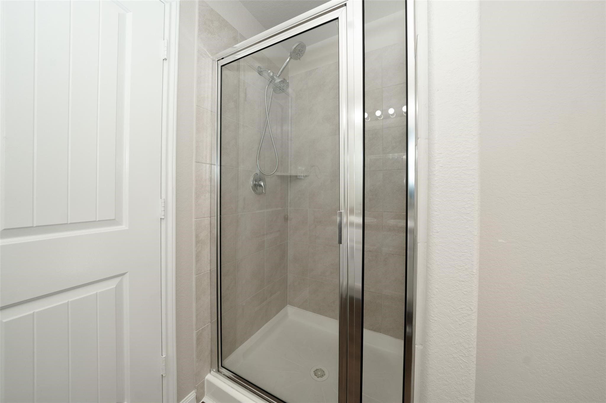 18834 Lansdowne Stream Path Katy, TX 77449 - Photo 15 of 21 a bathroom with a glass shower door