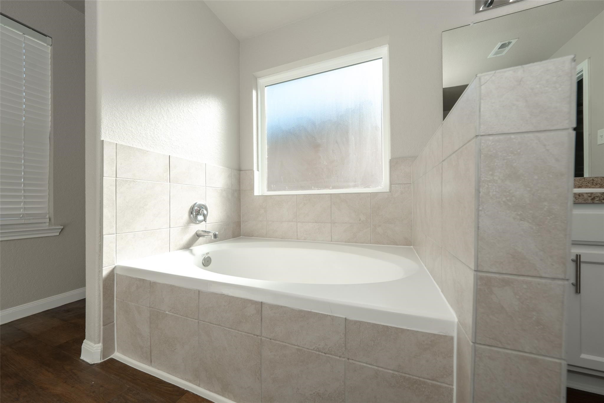 18834 Lansdowne Stream Path Katy, TX 77449 - Photo 16 of 21 a bathroom with a bathtub and a sink