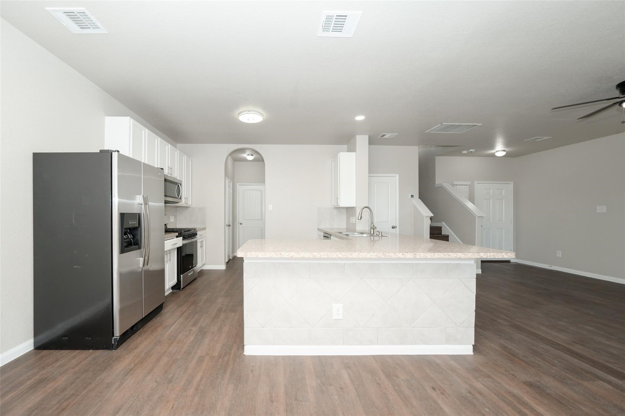 18834 Lansdowne Stream Path Katy, TX 77449 - Photo 7 of 21 a view of kitchen with refrigerator sink and wooden floor