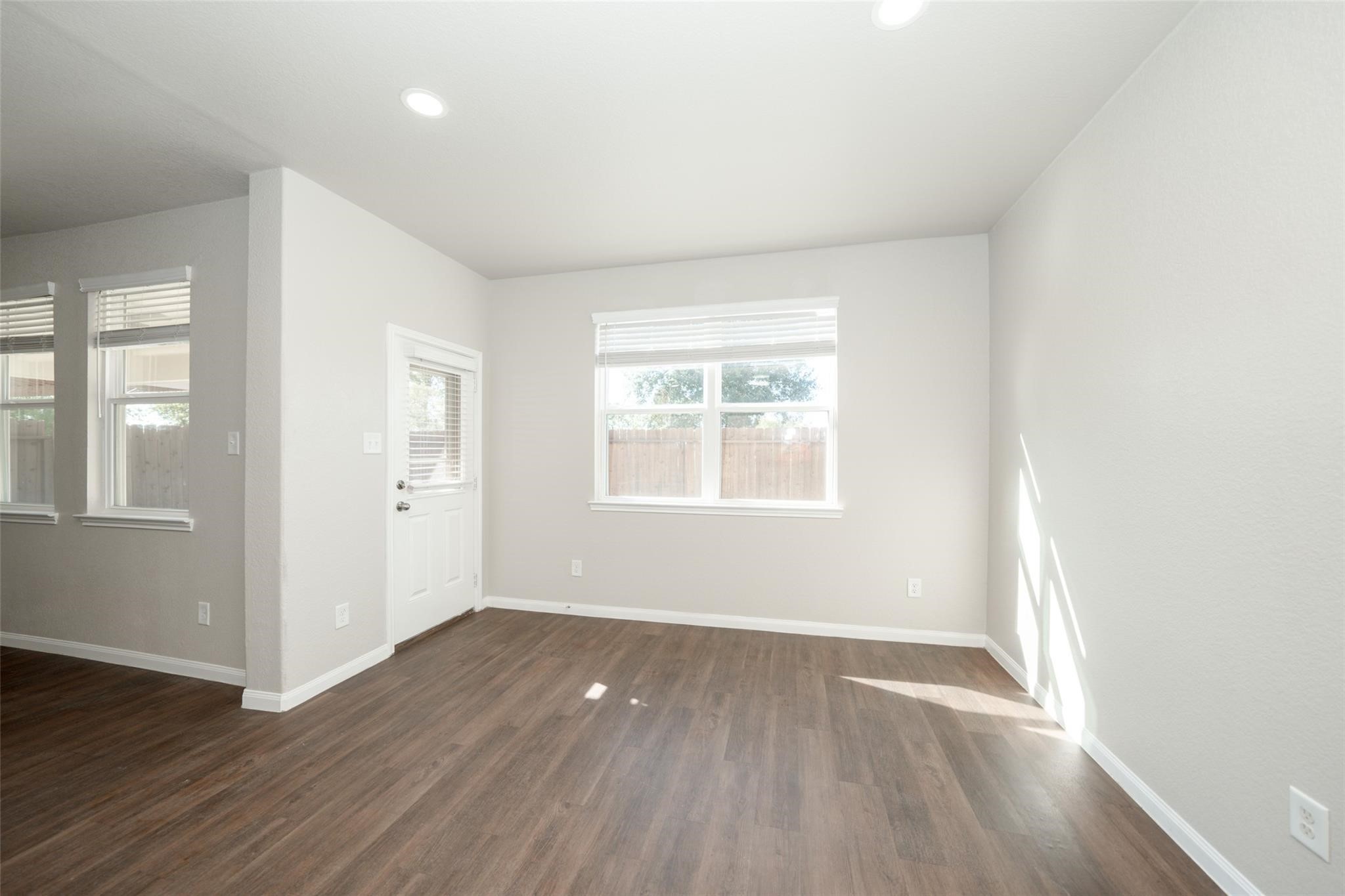 18834 Lansdowne Stream Path Katy, TX 77449 - Photo 9 of 21 an empty room with wooden floor and windows