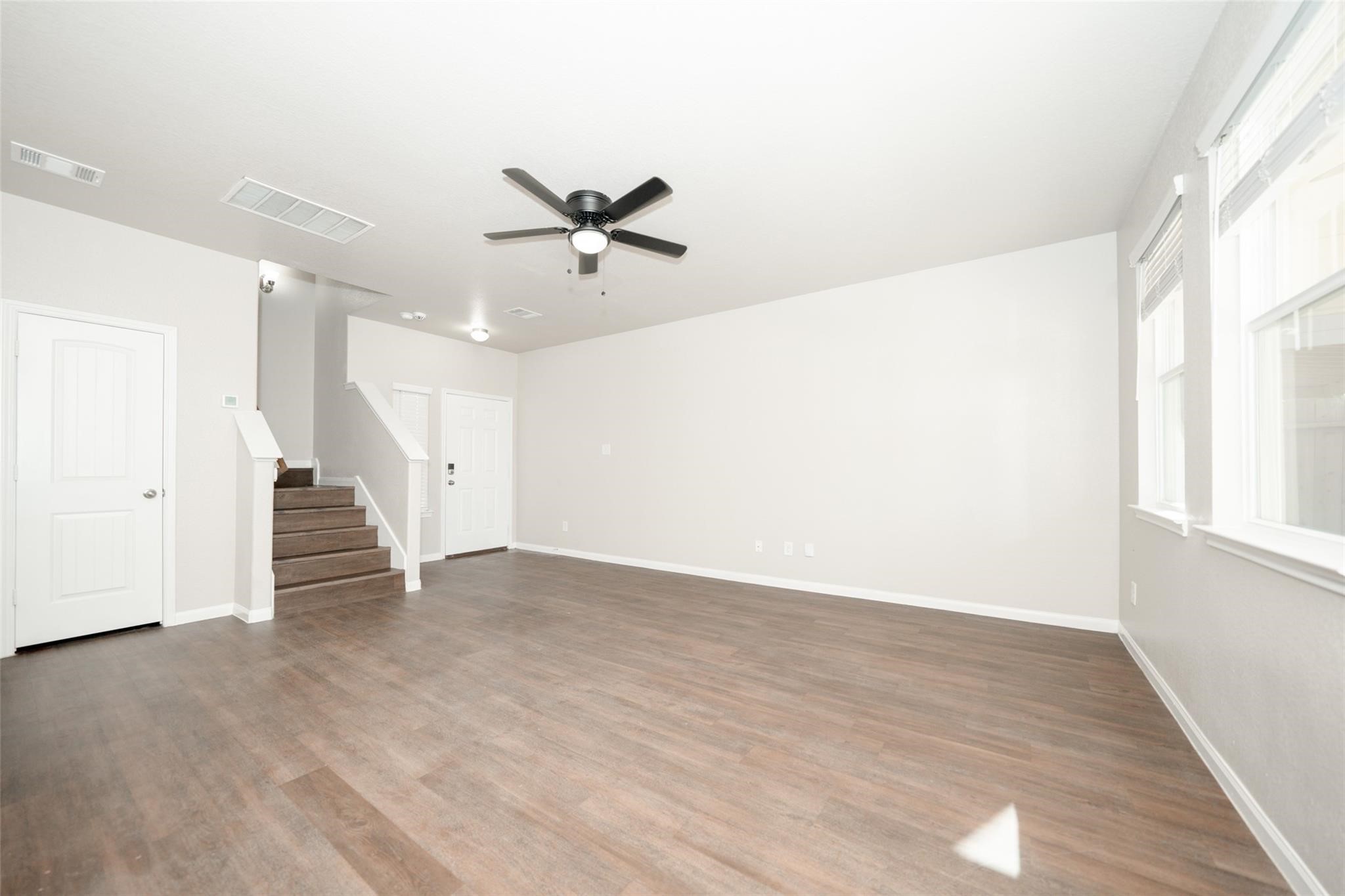 18834 Lansdowne Stream Path Katy, TX 77449 - Photo 10 of 21 a view of an empty room with wooden floor and a window