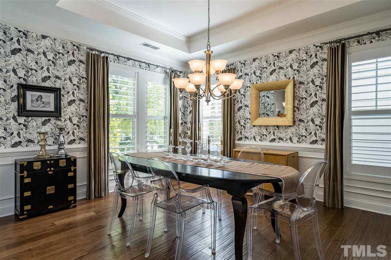 1400 Van Page Boulevard Raleigh, NC 27607 - Photo 8 of 30 Shutters, chandelier, tray ceiling, wainscoting, all leading to the butler's pantry.