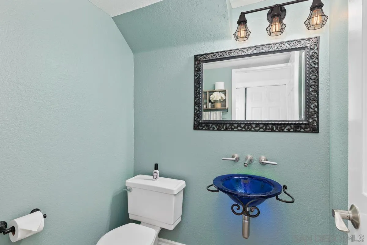 14680 Carmel Ridge Road San Diego, CA 92128 - Photo 16 of 33 a bathroom with a toilet sink and mirror