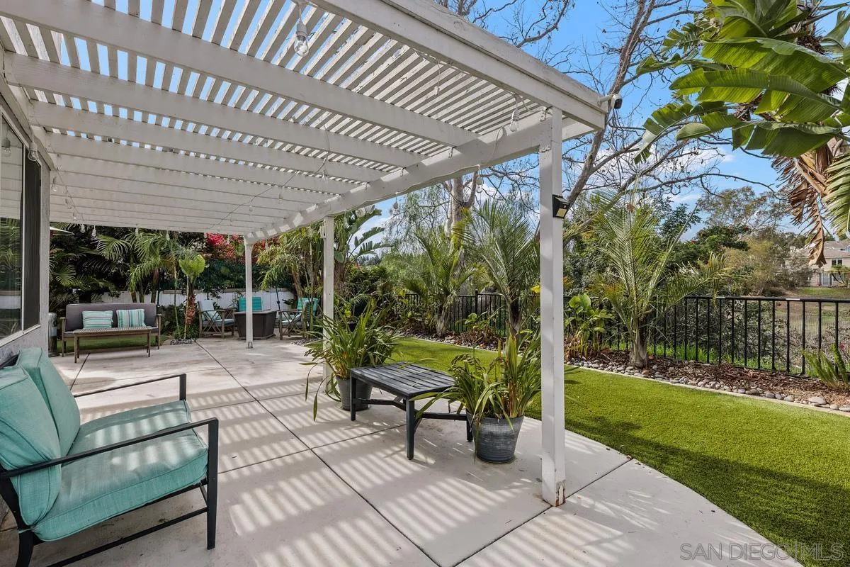 14680 Carmel Ridge Road San Diego, CA 92128 - Photo 31 of 33 a view of a patio with a table chairs and a backyard