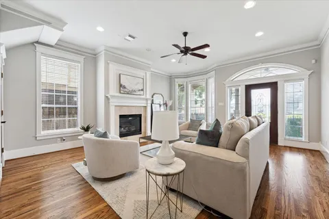 a living room with furniture a fireplace and a wooden floor