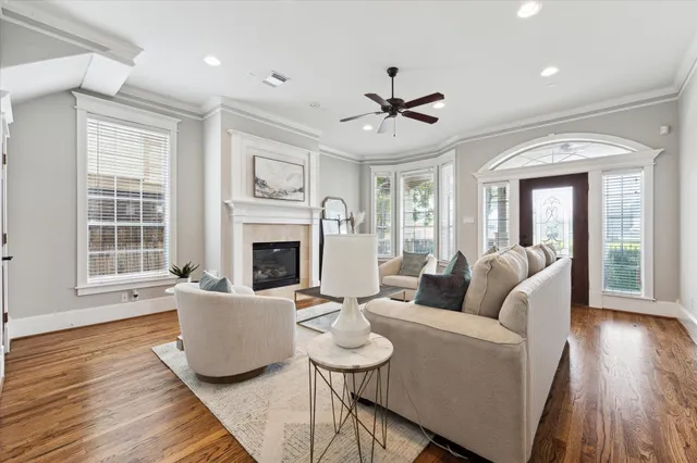 a living room with furniture a fireplace and a wooden floor