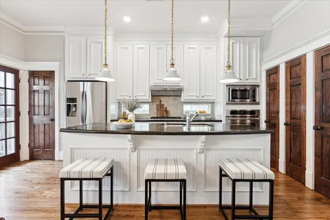 a view of kitchen with furniture and wooden floor