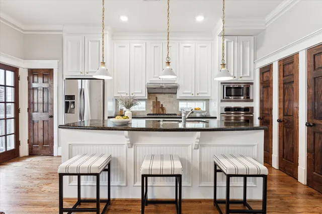 a view of kitchen with furniture and wooden floor