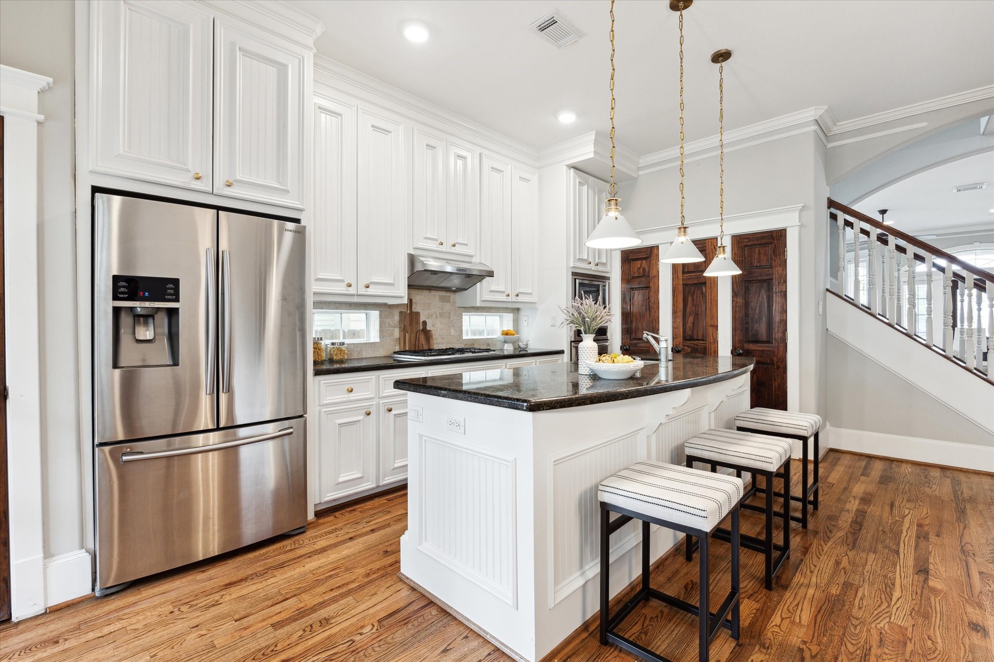 809 West 20th Street Houston, TX 77008 - Photo 19 of 39 a kitchen with stainless steel appliances granite countertop a refrigerator a sink dishwasher a stove and white cabinets with wooden floor